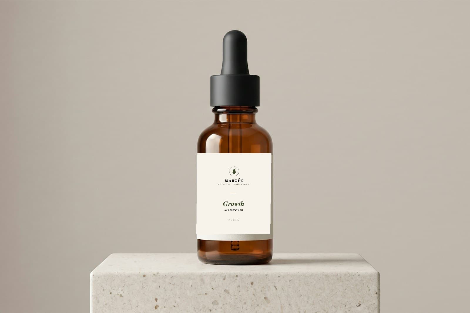 MARGÉE Growth Hair Growth Oil, amber glass dropper bottle on a stone pedestal